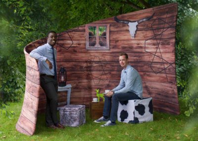 two men in printed fabric background