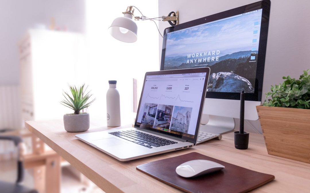 A workspace with a laptop, desktop monitor - Athlone Printing